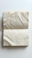 Handmade paper notebook with natural fiber texture and string binding on white background for craft projects and artistic documentation.
