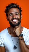 Hispanic man with bright smile and beard wearing white t-shirt against vibrant orange background. Studio portrait showing genuine happiness and confidence.