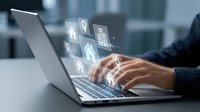 Professional typing on laptop with digital security icons floating above keyboard representing cybersecurity, data protection and online safety concepts.