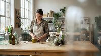 Young woman preparing healthy meal in modern kitchen with fresh ingredients and natural lighting for cooking lifestyle content.