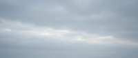 Overcast sky with soft gray and white clouds creating moody atmospheric background for weather forecasts, nature photography, and seasonal content design.