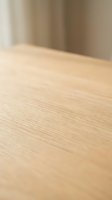 Light oak wood surface with soft focus background, suitable for product placement, interior design projects, and commercial advertising.
