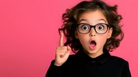 Young girl with curly hair and glasses showing surprised expression with raised finger against pink background, wearing black turtleneck. Great for education and idea concepts.