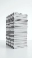 Tall stack of alternating gray and white books isolated on white background, suitable for education, library, and publishing design projects.