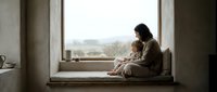Mother and child sitting together on window sill in cozy home interior, sharing intimate bonding moment with natural light streaming through large window.