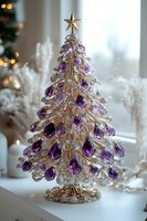 Elegant glass Christmas tree decoration with purple crystal ornaments and gold metallic finish topped with star, set against soft winter holiday background.
