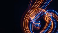 Abstract neon light trails creating dynamic swirls in orange and blue colors against black background for modern digital design projects.
