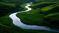 Winding river meandering through lush green rolling hills and valleys creating peaceful natural landscape for environmental and travel concepts.