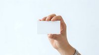 Caucasian male hand holding blank white business card or membership pass against neutral background for branding and corporate identity projects.
