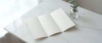 Open blank notebook with empty white pages on clean white bedding surface for journaling, writing, planning, and creative projects.