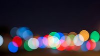 Abstract colorful bokeh lights creating dreamy blurred circles against dark background for festive celebrations and holiday decorations.
