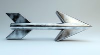 Metallic arrow sculpture with brushed steel finish and geometric design on light background, modern minimalist art piece showing direction and movement.