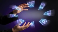 Hands holding glowing digital icons including clock, phone, settings, and envelope symbols floating in dark space, representing mobile app technology and digital communication interface.