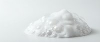 White fluffy foam or cream texture pile isolated on clean background for skincare cosmetic product design and beauty applications.