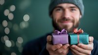 Happy bearded man in knit hat holding colorful wrapped gift boxes with ribbons during holiday season celebration.