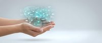 Hands holding glowing digital network connections with light particles, representing technology innovation, data transfer, and futuristic communication concepts.