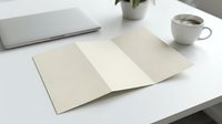 Clean minimalist workspace with open blank notebook, laptop and coffee cup on white desk for business planning and creative writing projects.