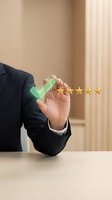 Businessman hand holding green checkmark with five golden stars rating for customer satisfaction and quality service evaluation.