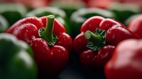 Fresh red bell peppers with green stems in close-up macro shot showing glossy texture and vibrant colors for healthy cooking and nutrition concepts.