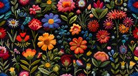 Vibrant wildflowers pattern with red, orange, and blue blooms on black background creates dramatic floral composition for fabric, wallpaper, and surface design.