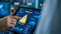 Close-up of hand touching tablet displaying security alert warning icon with data analytics dashboard for cybersecurity, threat detection, and system monitoring applications.