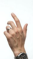 Male hand making OK gesture with silver wedding ring and luxury watch isolated on white background for business communication concepts.
