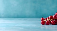 Fresh red currant berries on turquoise blue background with copy space. Minimal food photography style for healthy eating and summer berry concept.