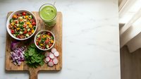 Fresh healthy quinoa salad bowls with vegetables and green smoothie on wooden board, clean eating meal prep concept for nutritious lifestyle.