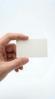Male hand holding blank white business card on clean background for corporate branding and professional presentation mockup design template.