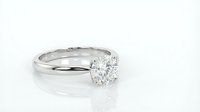 Diamond solitaire engagement ring with round brilliant cut stone on white gold band isolated on white background for jewelry design.