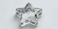 Clear glass star-shaped bowl or dish isolated on white background for modern home decor and table setting design projects.