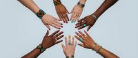Diverse hands reaching together in unity circle showing teamwork collaboration and inclusion concept for business community projects.