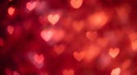 Red heart bokeh lights background for Valentine's Day romance celebration and love themed designs with soft glowing effect.