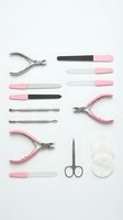 Professional manicure pedicure tools set with pink handles on white background for nail care salon beauty treatment isolated.