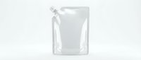 Blank white stand-up pouch with spout cap isolated on light background, mockup for branding, packaging design, and product presentation.