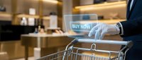 Businessman using digital tablet with buy now button for online shopping in modern kitchen setting with shopping cart for e-commerce purchases.