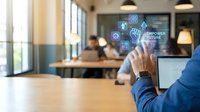 Businessman in blue shirt touching digital holographic interface with empowerment icons and team collaborating in modern office workspace for business technology and corporate solutions.