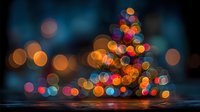 Blurred Christmas tree with colorful bokeh lights creating magical holiday atmosphere on dark blue background for festive seasonal decorations.