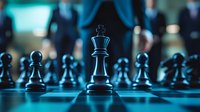 Chess king piece standing tall among pawns on chessboard with blurred business people in background, representing leadership and strategy in corporate world.