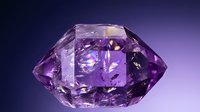 Purple amethyst gemstone with brilliant cut facets reflecting light on gradient background for luxury jewelry and precious stone designs.