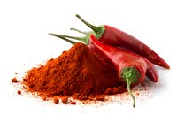 Fresh red chili peppers with heap of ground paprika powder on white background, essential ingredients for spicy cuisine and cooking.