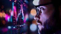 Side profile of bearded Asian male trader analyzing financial market data on digital screen with neon pink and blue lighting effects and bokeh background.