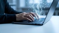 Businessman hands typing on laptop keyboard with digital binary code data stream flowing upward representing cybersecurity and data processing.