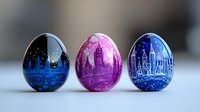 Decorative Easter eggs featuring city skyline silhouettes painted in vibrant blue and pink colors against starry night backgrounds, arranged in artistic composition.