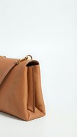 Elegant brown leather handbag with gold hardware isolated on white background for fashion and accessory design projects.