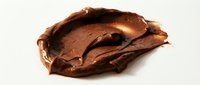 Isolated chocolate spread smear on white background, ready for design use on packaging, websites, and marketing materials.