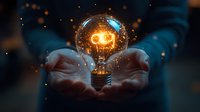 Glowing light bulb floating above cupped hands with magical sparkles and bokeh effects against dark background, symbolizing innovation and creative energy.