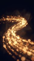Golden light particles flowing in dynamic spiral motion creating magical energy stream with bokeh effects on dark background for digital art projects.