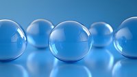 Transparent glass spheres with reflective surfaces arranged on blue background, suitable for technology, science, and abstract design projects.