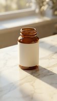 Amber glass medicine bottle with blank white label on marble surface in natural sunlight for pharmaceutical and healthcare branding mockup.